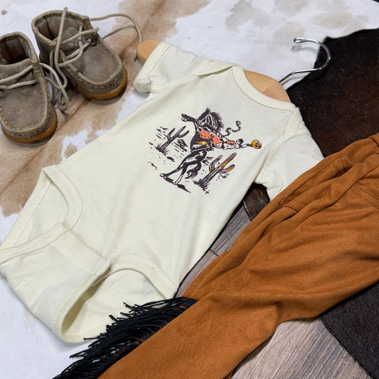 Cream onesie with bucking bronco cowboy.