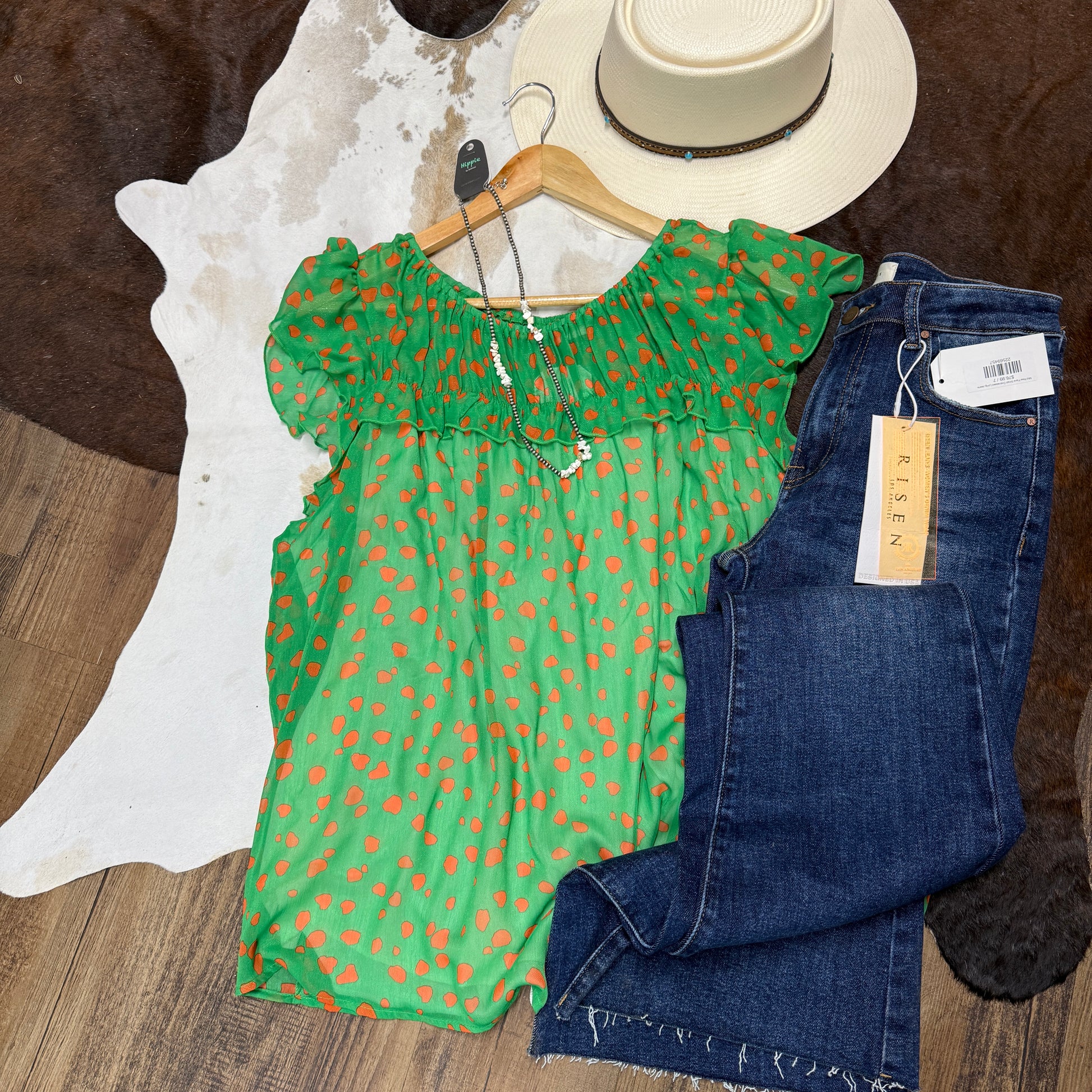 Green chiffon top with orange dots.