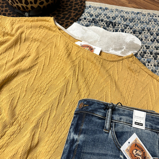 Close up of knit texture on shirt.