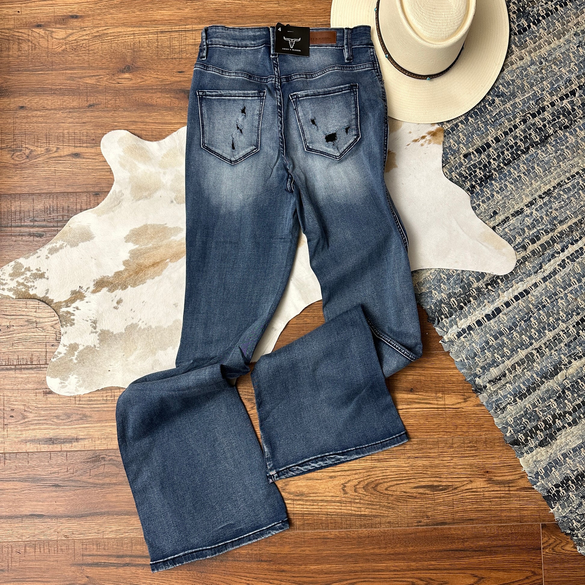 Backside view of acid wash jeans with button fly.