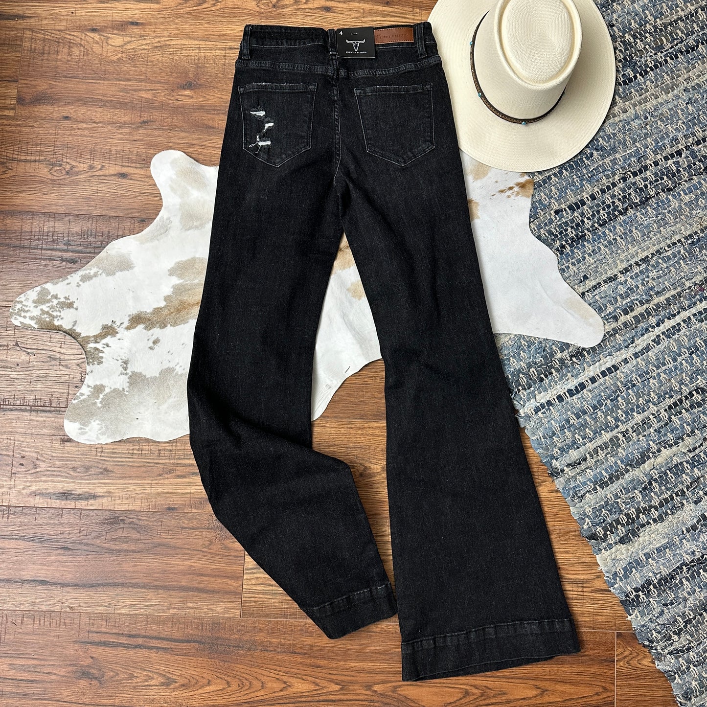 Back side of black washed trouser flares.