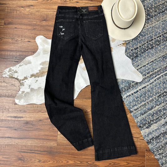 Back side of black washed trouser flares.