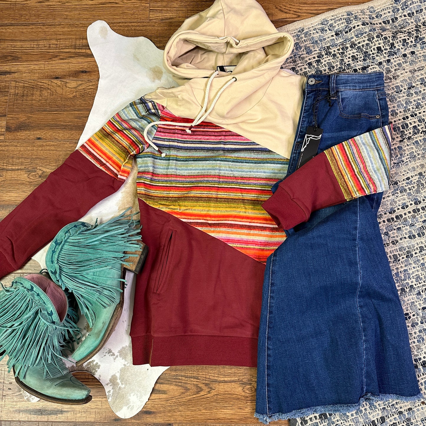 Hoodie with diagonal colorblocking of ivory, serape, and burgundy.