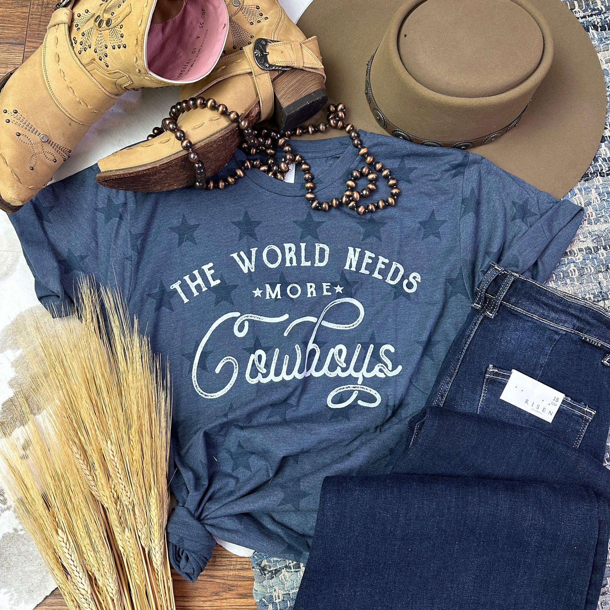 Navy star tee with The World Needs more Cowboys printed. onit.