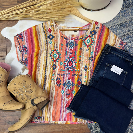 Soft serape with embroidered aztec design.