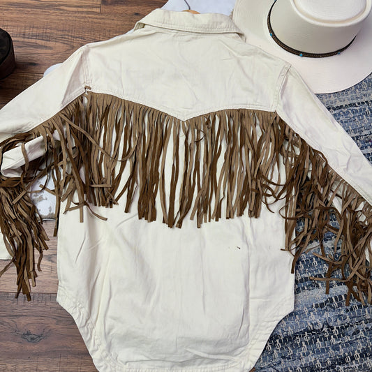 Ivory denim jacket with brown fringe.