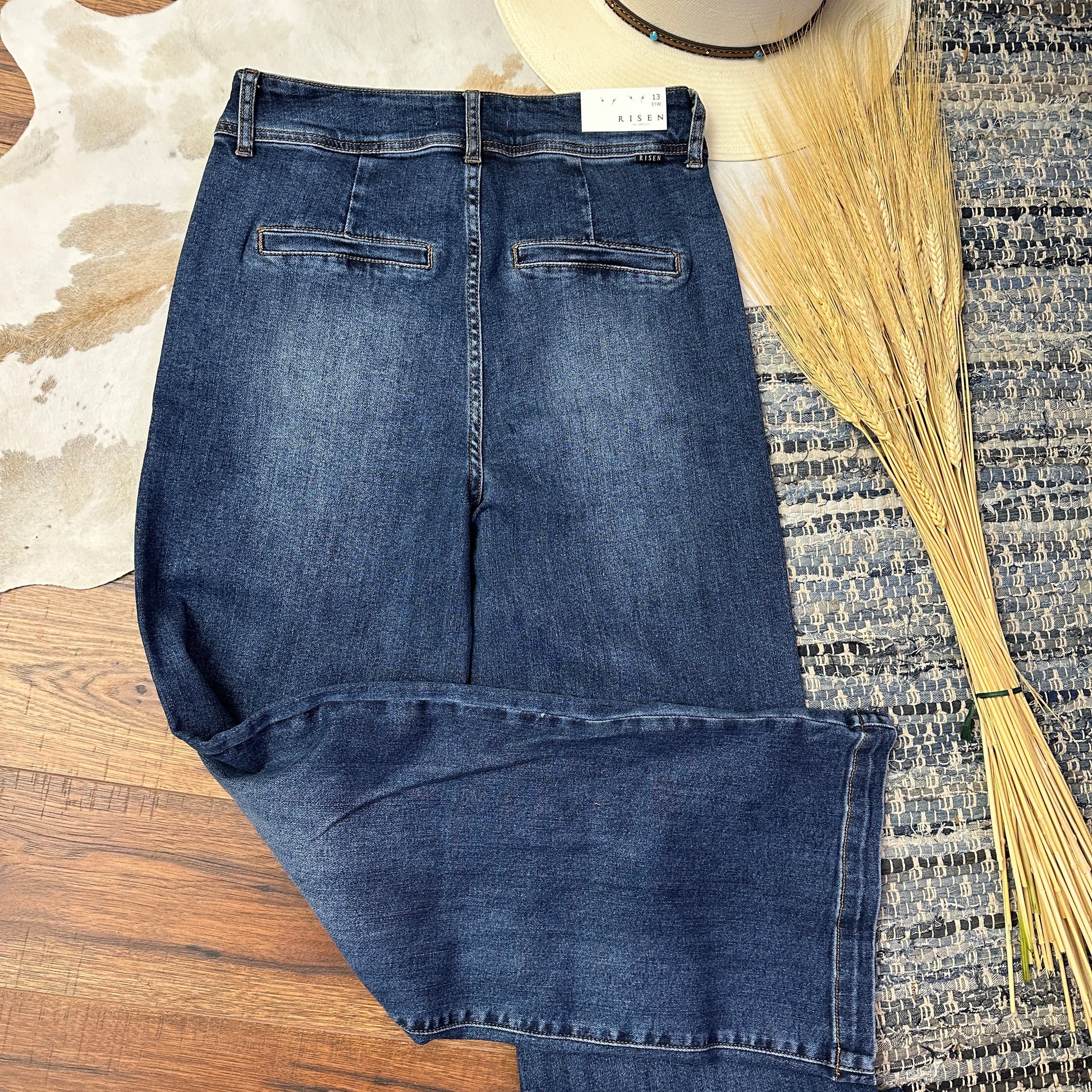 Rear pockets of wide legged denim.