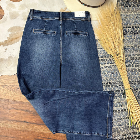 Rear pockets of wide legged denim.