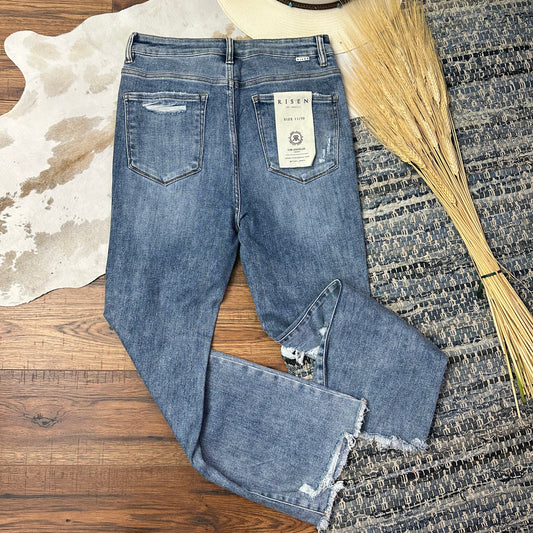 Back pockets of medium wash destroyed ankle crop pants