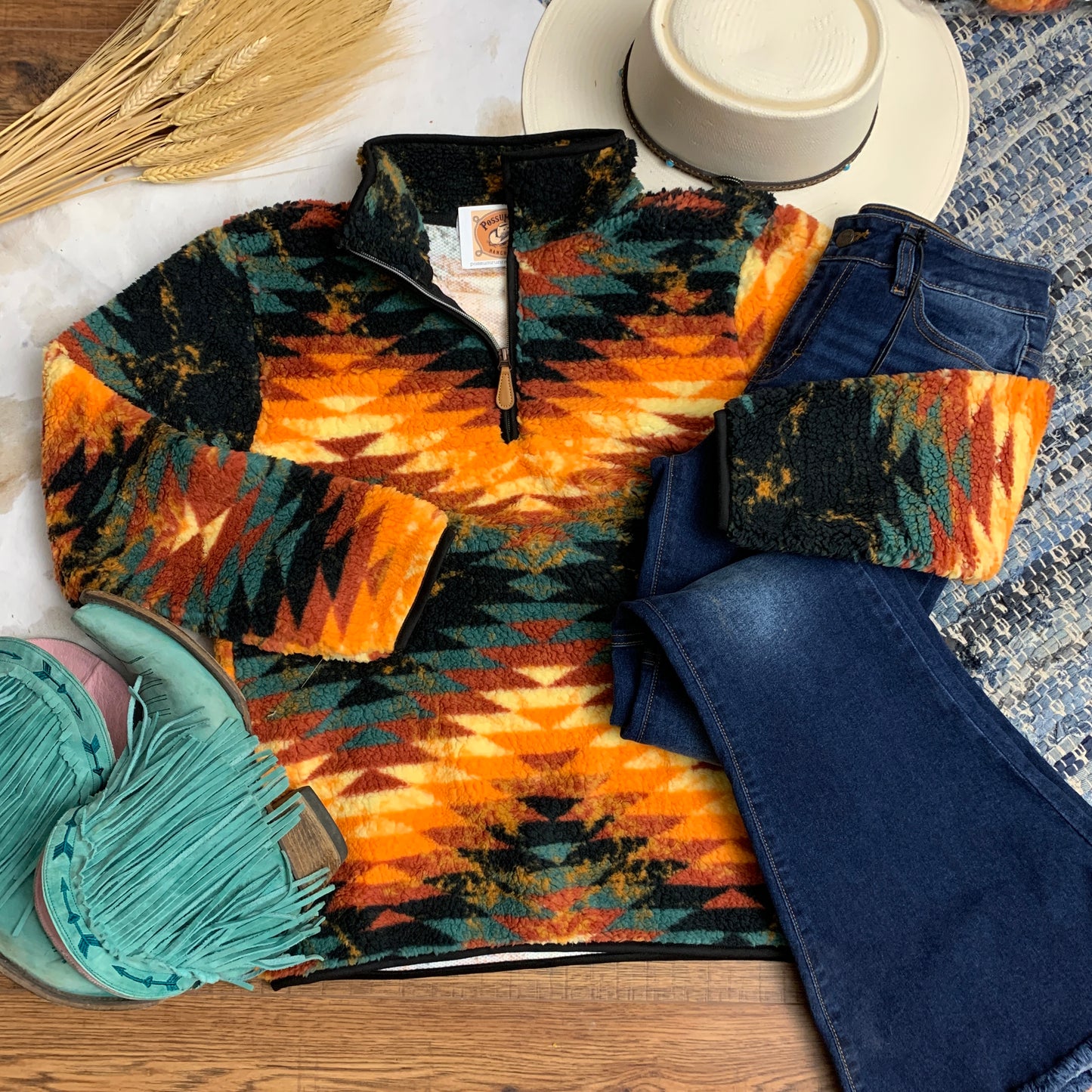 Aztec fleece quarter zip sweater paired with jeans and boots.