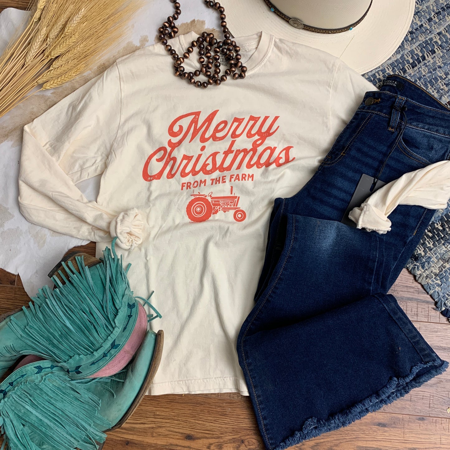 Ivory long sleeve tee with red lettering that says "Christmas on the Farm"