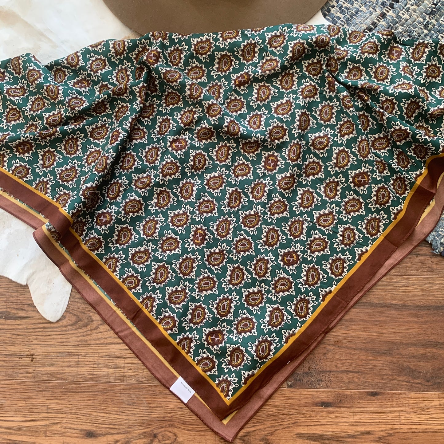 Green background with burgundy and gold paisleys.