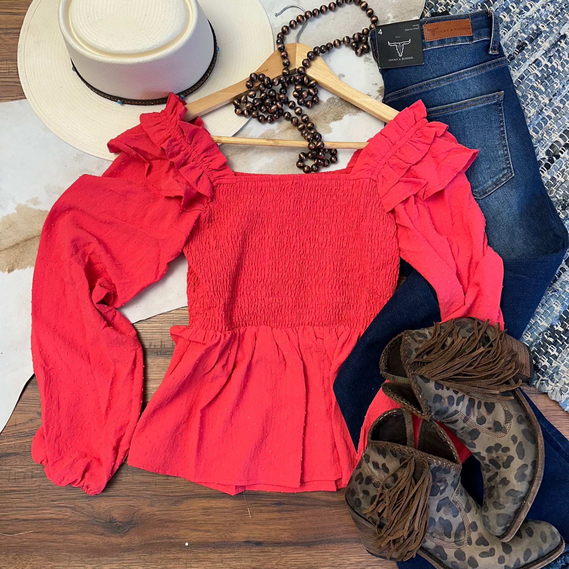 coral pink swiss dot fabric with a smocked yoke and ruffles.