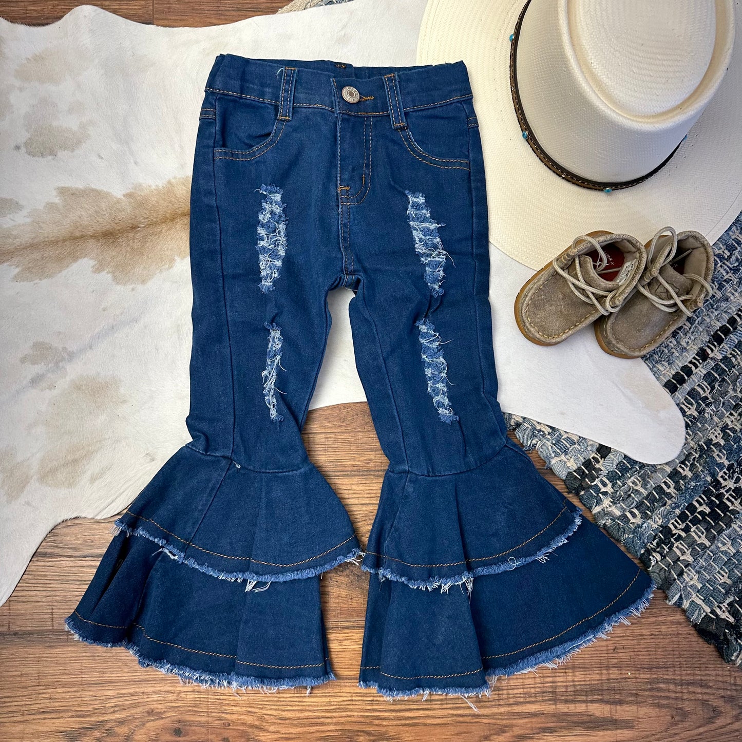 Distressed double bell bottoms in a medium wash. Kids.