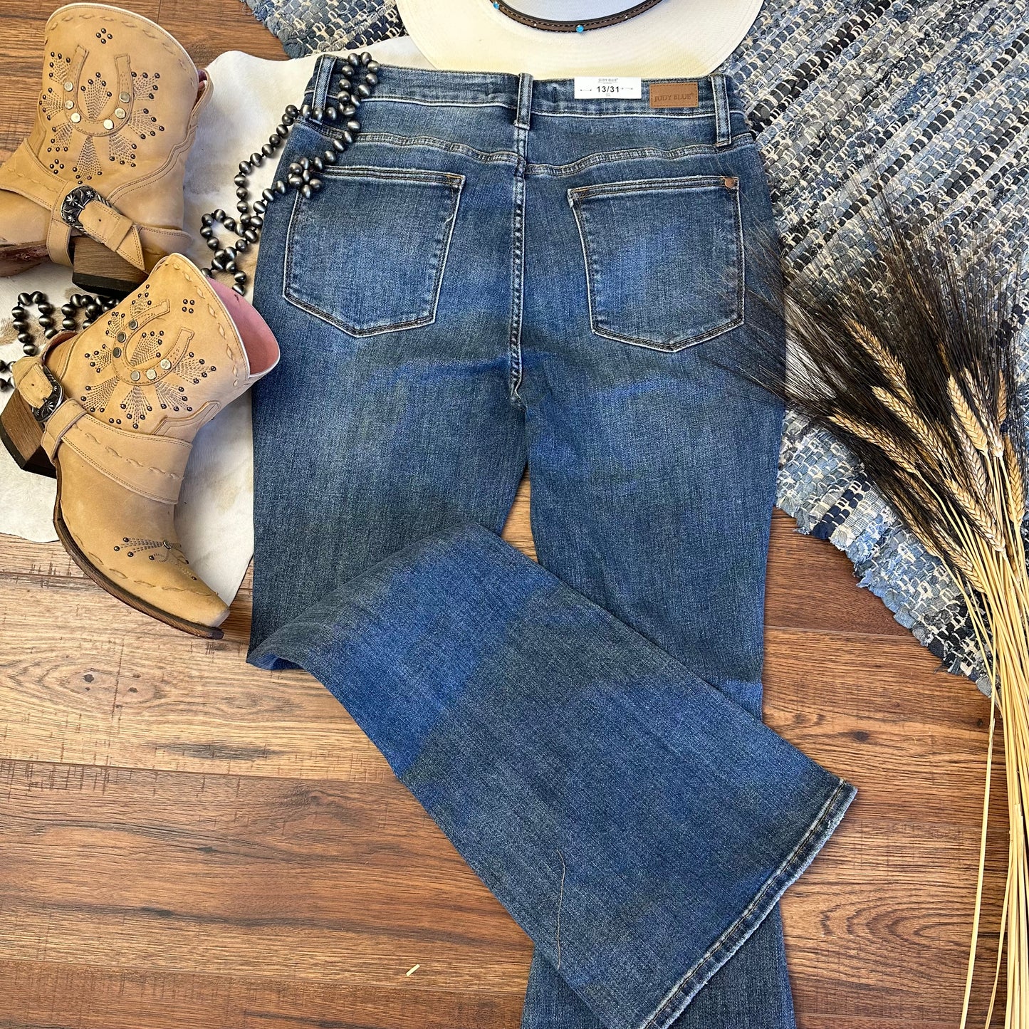 Rear view of distressed denim jeans.