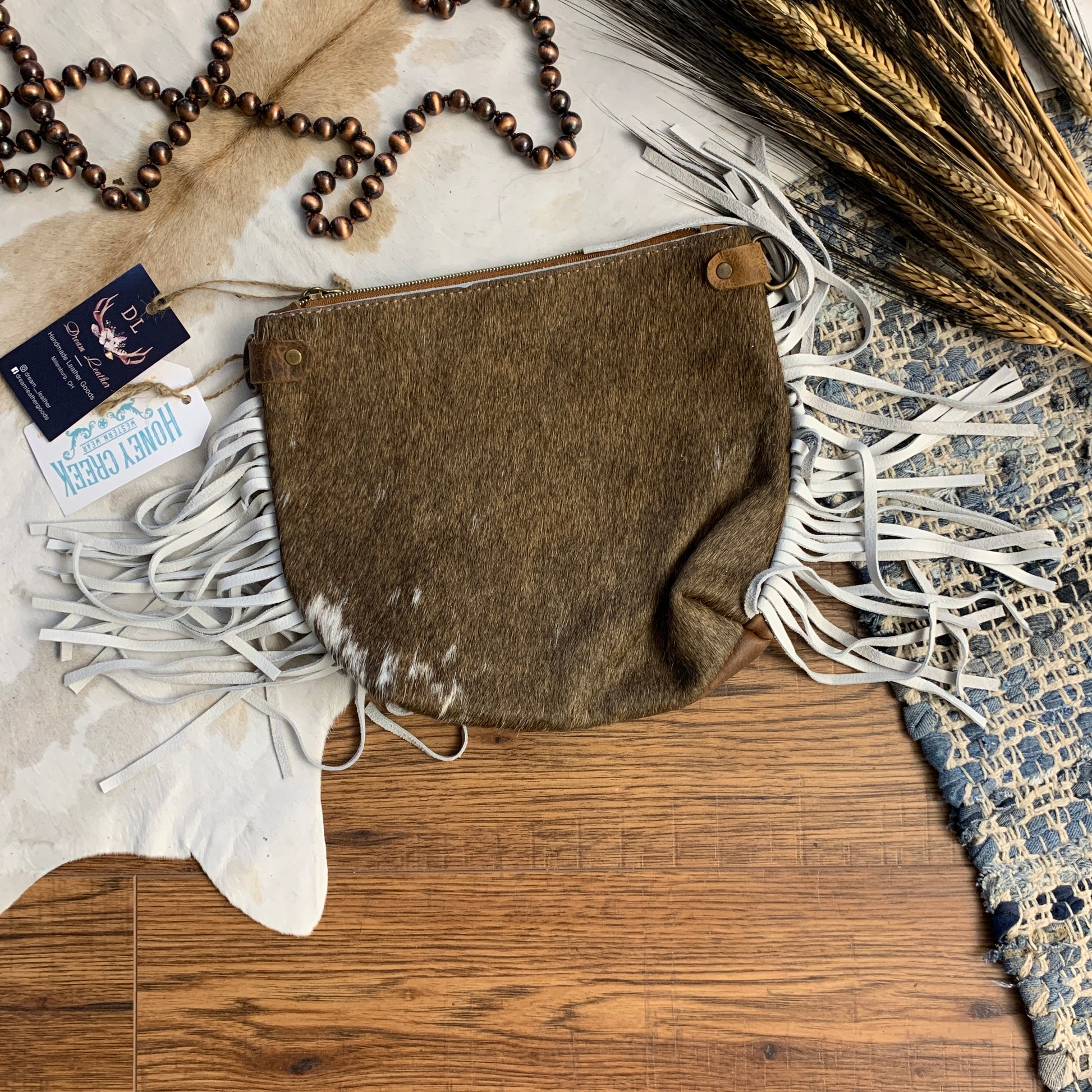 Light brown bag with white side fringe.