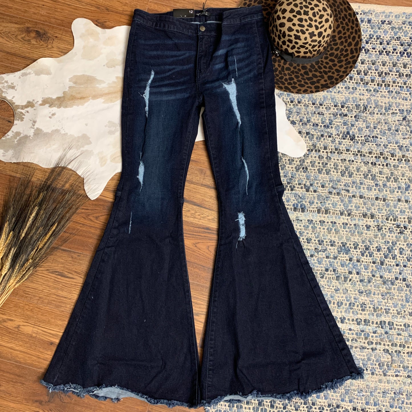 dark wash extreme flare with distressed front panels and hemline.