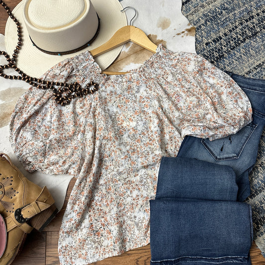 PEach and Taupe colored ditzy floral pattern on a shoulder smocked woven top.