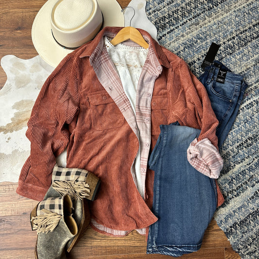 rusty orange corduroy jacket that has a fleece plaid recversible lining.