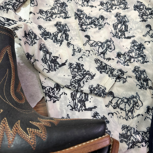 Close up of cowboy toile pattern.