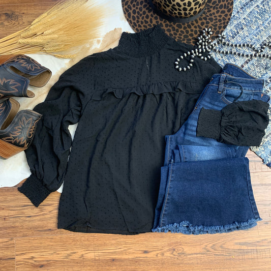black swiss dot high necked blouse, paired with jeans and boots.