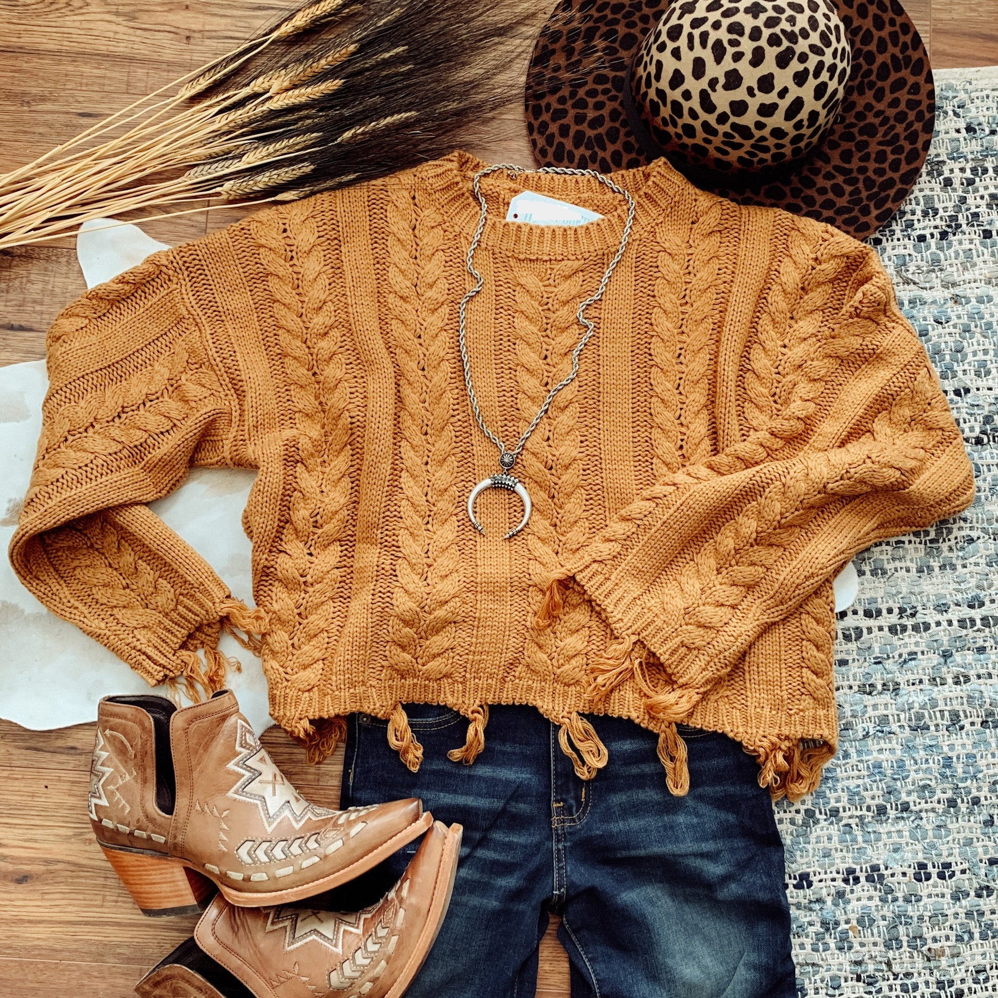 Flat lay of caramel colored sweater.