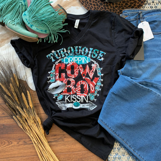 View of tee graphic, Turquoise Drippin' Cowboy Kissin'. Black tee.