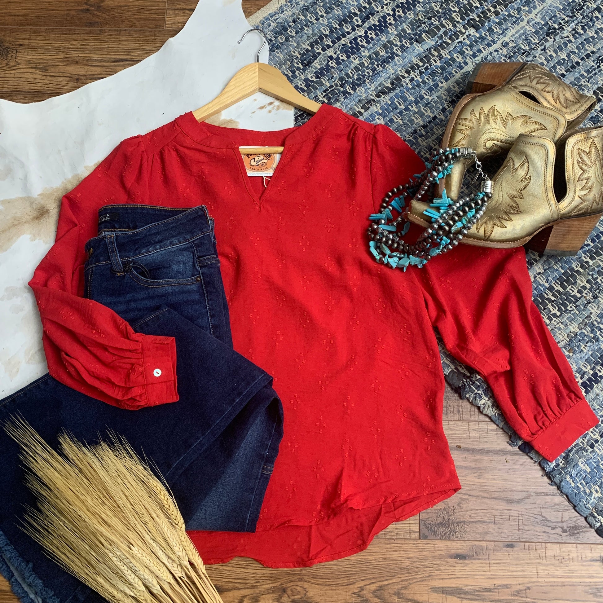 Red swiss dot top paired with jeans, and gold booties.